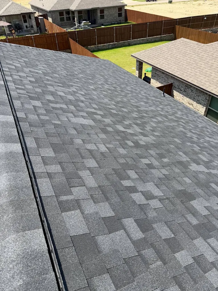 Wide angle of finished gray shingle roof